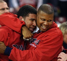 Lutheran coach Eric Cooper (right)
bearhugs hero Kevin Payne following
team's state title victory. Payne's
father died in a car accident last
summer.