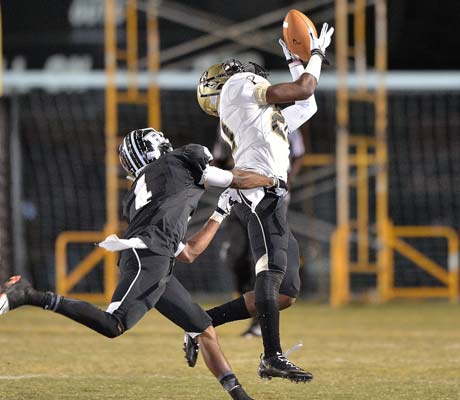 Plant's Tristan Cooper makes a leaping catch in front of a Robinson defender.