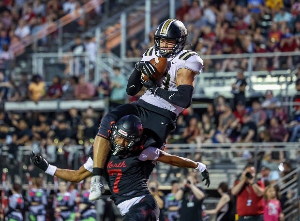Raymore-Peculiar's Jaden Redell makes a touchdown catch on top of Lee's Summit North's Michael Lane. (Photo: David Smith)