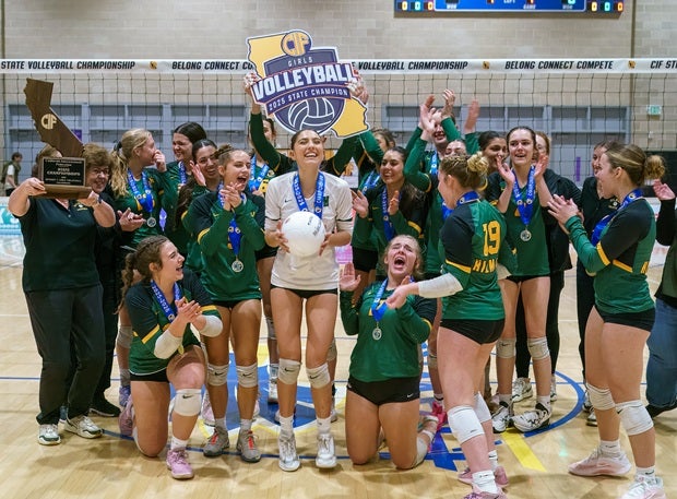 Hilmar celebrates its CIF Division V volleyball title on Friday. The Yellowjackets swept Elsinore to win their first state title. (PHOTO: Diane Torrence)