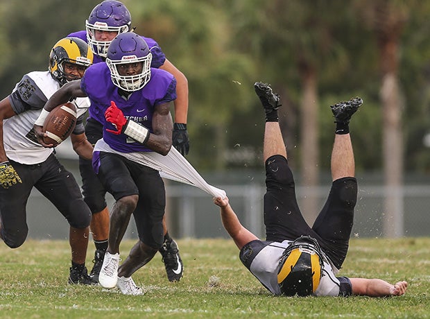 Fletcher (Fla.) receiver Jeremiah Payton attempts to elude the grasp of Englewood linebacker Dylan Nesbitt.