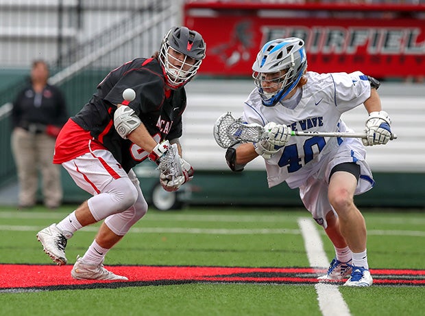 Nick Crovatto of New Canaan (Conn.) and Darien's Tanner Strub (right) eye a loose ball during a CIAC Class L semifinal lacrosse game.
