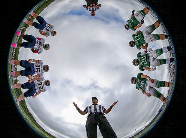 Players from Freehold Boro (N.J.) and Colts Neck circle up for the coin toss before a varsity football game.