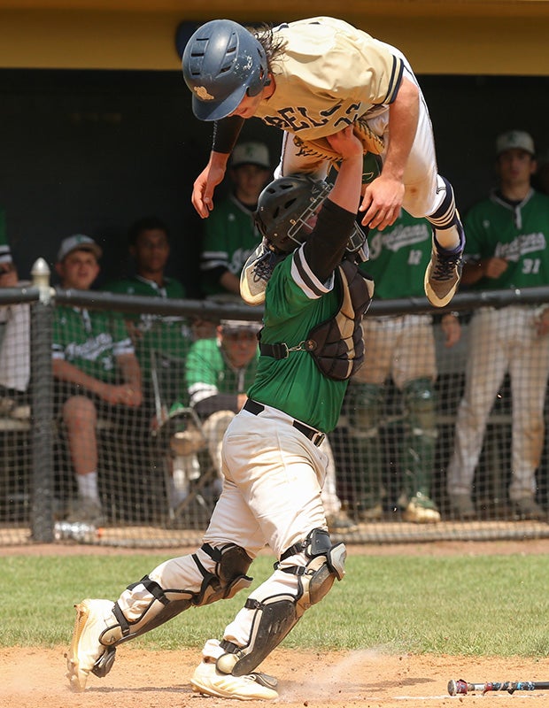 Michael Roumes of Roxbury (N.J.) attempts to hurdle Pascack Valley catcher Austin Piorkowski but is tagged out during the NJSIAA North 1 Group 3 title game.