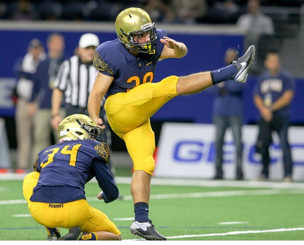 Aquinas kicker Marco Salani connects on one of his three first-half field goals.