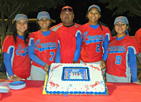 Will Garcia, middle, poses with his players. Las Cruces finished the season with a 5A title and just one loss.