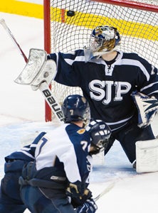 Brendan Collier (7) scores in OT.