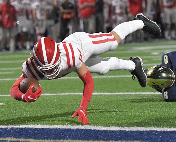 Receiver Jack Ressler dives into the end zone for a Mater Dei touchdown in the third quarter to give the Monarchs a 35-21 lead.