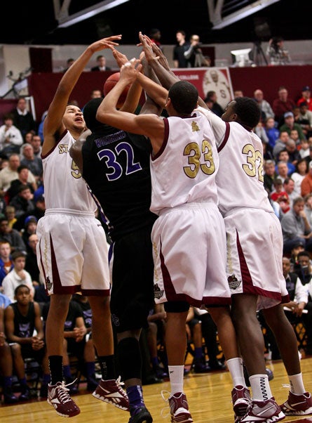 Anderson (left) and teammates converge on Tony Parker of Miller Grove at the Spalding Hoophall Classic in January. Typical of Bob Hurley-coached teams, defense was St. Anthony's calling card in 2011-12, limiting opponents to 36.6 points per game.