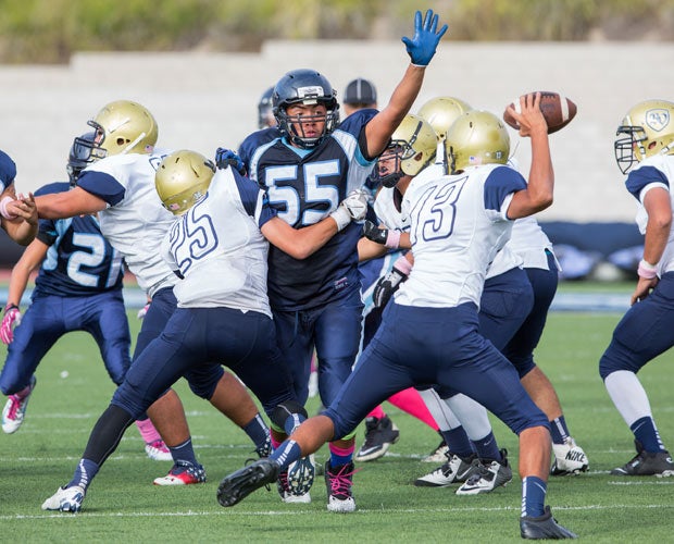 Otay Ranch (Calif.) lineman Kyle Caliver looks to deflect a pass attempt by a Bonita Vista quarterback during a junior varsity game. 