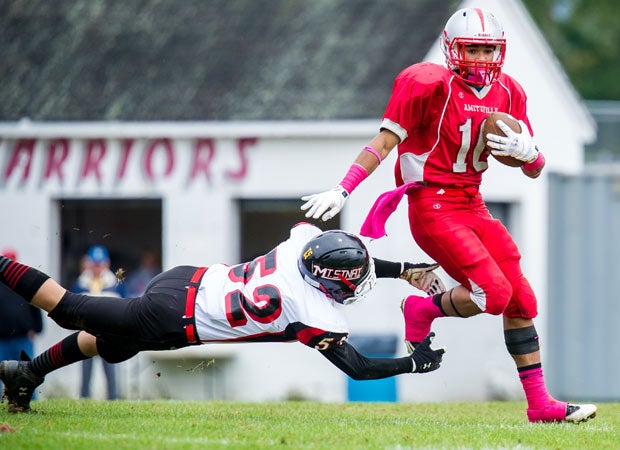 Amityville Memorial (N.Y.) receiver Brendan Paula attempts to elude diving Mount Sinai linebacker Appio Fragoletti. 