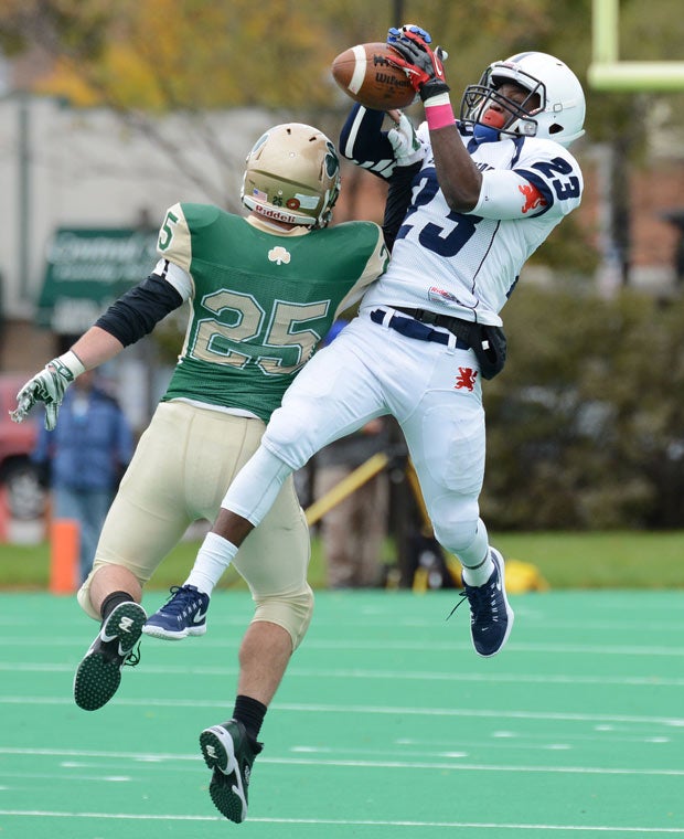 Saint Viator (III.) receiver Darroenta Jackson attempts to make a leaping catch in front of a St. Patrick defender.
