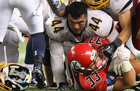 Isaac Savaiinaea (44) of Punahou, one of the best linebackers in the country, has a tough choice ahead of him.