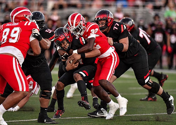 Mater Dei linebacker Abduall Sanders puts the wraps on on Centennial quarterback Husan Longstreet during Friday night's clash in Southern California. (Photo: Louis Lopez)