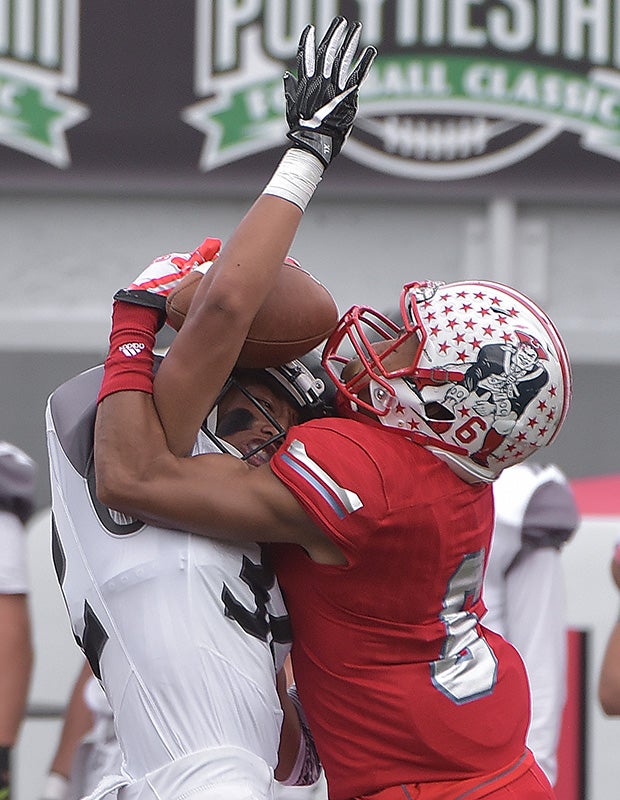 Liberty (Nev.) receiver Cervontes White (right) makes a circus-like catch over Alta (Utah) linebacker Gooch Malietulua during the Polynesian Football Classic at Sam Boyd Stadium in Las Vegas.