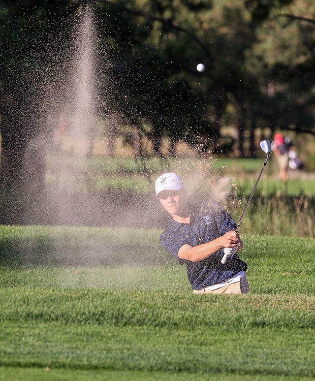 A golfer hits out of a sand trap during the Kadet Invitational in Colorado.