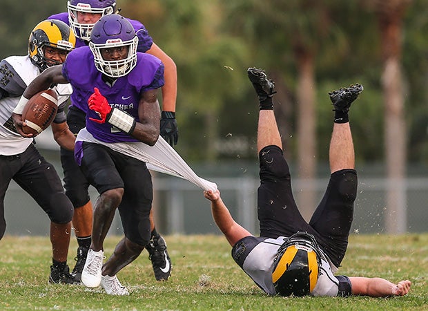 Fletcher (Fla.) receiver Jeremiah Payton attempts to elude the grasp of Englewood linebacker Dylan Nesbitt.