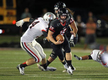 Trinity quarterback Matt Hawkins gets out of a jam, helping his team take a tough and tenacious 21-18 win over Oklahoma rival Union late Saturday in the Southwest Showdown. 