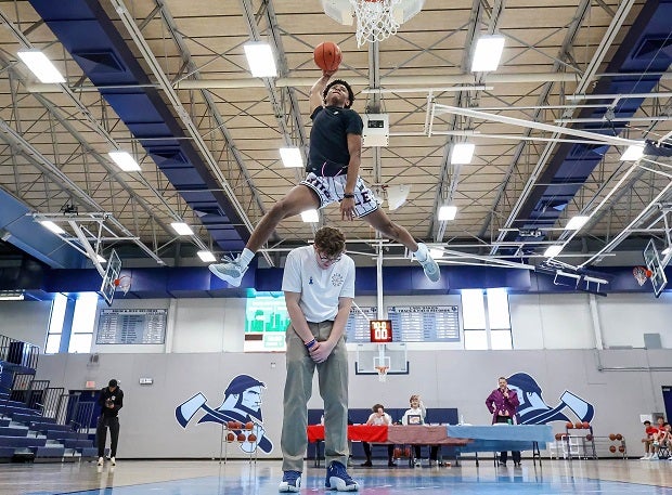 London Burton of Aquinas soars over Landon Hinkle during the Metro Sports KC All-Star Game Dunk Contest in Gladstone, Mo. Burton won the competition. (Photo: David Smith)