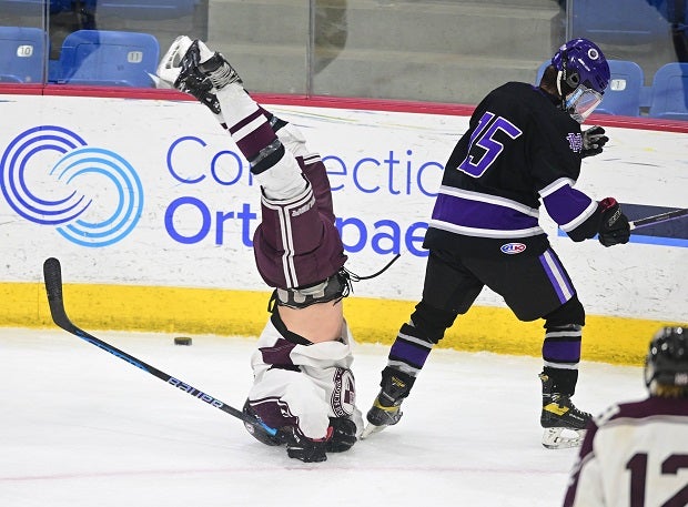 North Haven senior wing Tommy Guidone is upended and lands on his head in DII State semifinal game. Guidone got right up and kept skating. (Photo: Kevin Pataky)