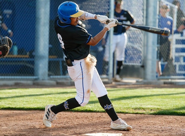 A Mira Mesa varsity baseball player fouls a pitch off himself. (Photo: Michael Cazares)