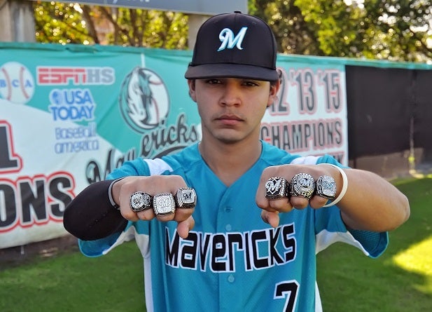 Jose Martinez of Archbishop McCarthy shows off the team's six state championship rings. The Mavericks will have to add a seventh after their win over Jesuit.
