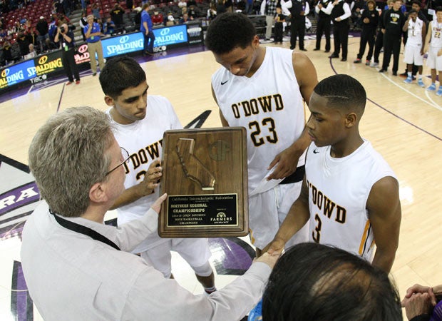 Bishop O'Dowd's captains accept the hardware presented by CIF Executive Director Roger Blake after winning their second straight Open Division Northern California title.