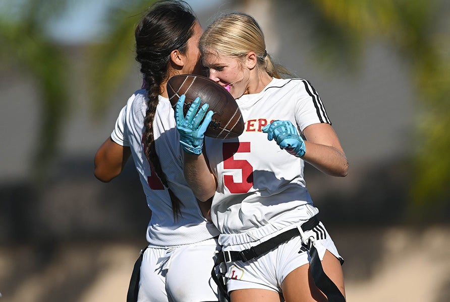 Orange Lutheran's Ava Harrison (1) and Claire Dahman (5) celebrate during a recent victory. The Lancers climbed to No. 4 in this week's MaxPreps Top 25. (PHOTO: Marc Gewertz)