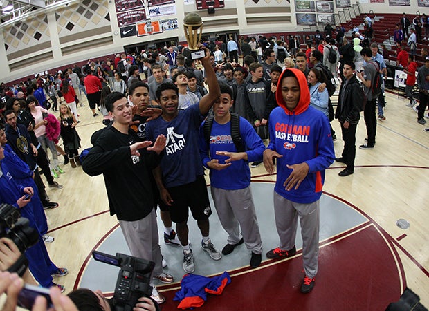 Christian Popoola celebrates being crowned the dunk champion along with a few teammates.