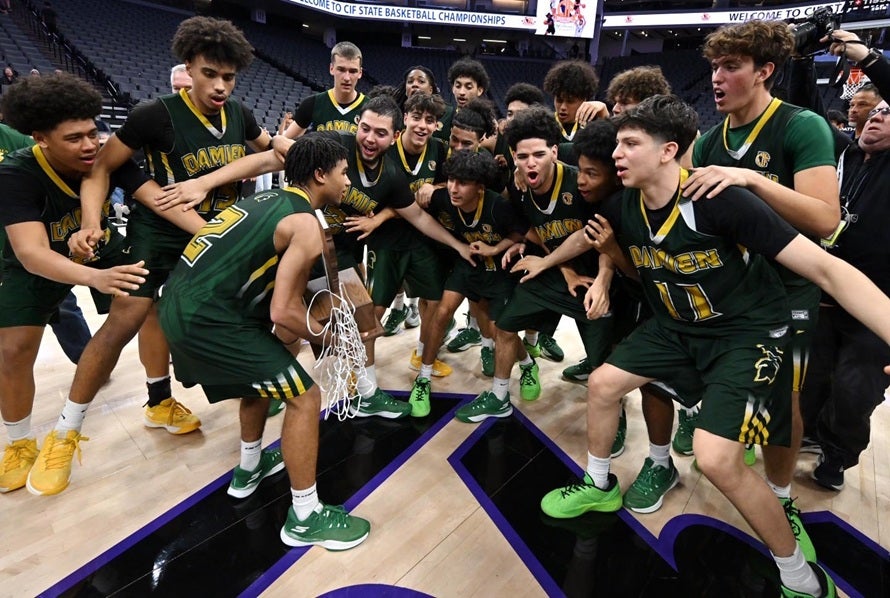 Damien players celebrate the program's second CIF state title Friday after winning the Division I crown 58-55 over Folsom. (PHOTO: David Steutel)