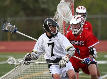 Arapahoe's Tyler Widlund (7) scored three goals, including the game-winner in the final 30 seconds as the top-seeded Warriors beat Columbine in the state semifinals on Wednesday.