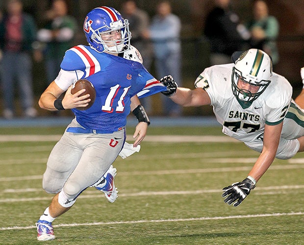 Memphis University (Tenn.) quarterback Bobby Wade attempts to elude Briarcrest Christian defensive lineman Griffin Hawkins.