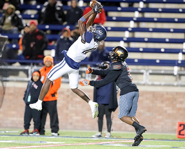 Wylie East (Texas) Ronald Smith leaps to make a catch in front of Lancaster cornerback Jaymir Sparrow in a UIL state playoff game.