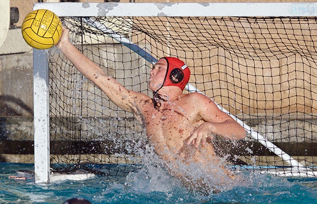 El Camino (Oceanside, Calif.) goalie Jake Huggins dives while deflecting a shot against Ocenaside.