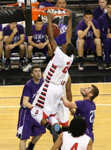 Dublin's JoJo McGlaston finishes with
a dunk. He had Division record 35
points.