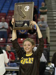 St. Francis starter Lauren Johnson
holds up her team's first-ever
NorCal title plaque.