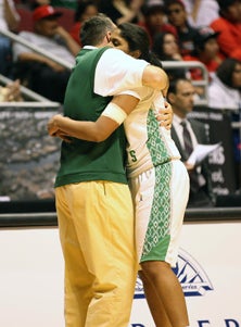 Curtis Ekmark embraces one of his
team's only two seniors, Shilpa
Tummala, following the title game.