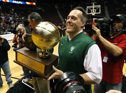 Curtis Ekmark holds up the trophy following his team's championship game victory over Hamilton. St. Mary's not only won a second-straight Arizona crown, but the state's first mythical national title.
