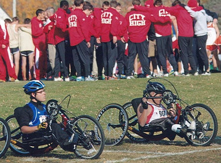 Drake Sachsenmeier of Camanche High (left) and Jordan Houdeshell of Linn-Mar High School get set to start in an Iowa cross country meet.