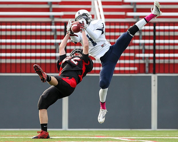 Isaiah Brown of Gates Chili (Rochester, N.Y.) attempts to snag the ball out of the hands of the Penfield (N.Y.) defender.