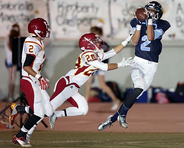 Connor Van Ginkel of Crescenta Valley (La Crescenta, Calif.) hauls in a pass over Arcadia (Calif.) defenders.
