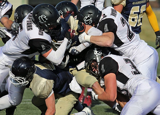 A group of defenders from Silver Creek (Longmont, Colo.) try to bring down the Evergreen (Colo.) ball carrier.