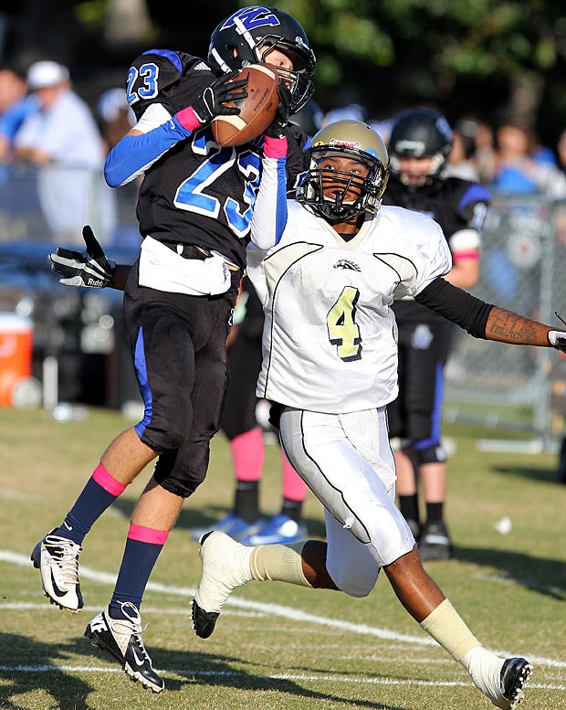 Alex Rubinek of Windward (Los Angeles) pulls down a pass in front of Jeffery Phillips of Kilpatrick (Malibu, Calif.).