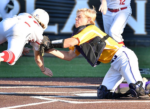Edgewood (Texas) catcher Hunter Robinson tags out a diving Pottsboro baserunner during a game in the UIL 3A Region 2 playoffs.