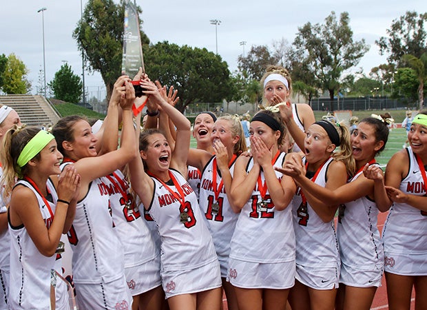 Mater Dei (Santa Ana, Calif.) players react to teammate Grace Houser (8) who nearly dropped the championship trophy while celebrating their victory in the CIF Southern Section Orange County title game.