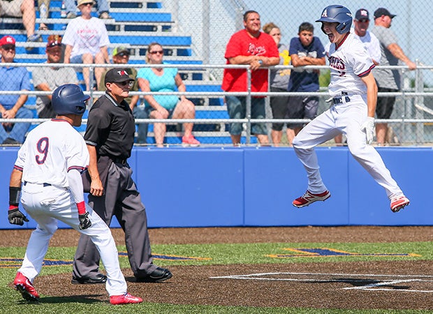 Dylan Ditzenburger (right) of Allen (Texas) leaps while celebrating his winning run during a game against Harker Heights in a UIL 6A Regional 1 playoff game.