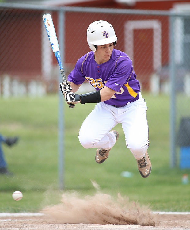 Matthew Cusamano of Plymouth Christian Academy (Canton, Mich.) leaps to avoid a wild pitch during a game against Huron Valley Lutheran.