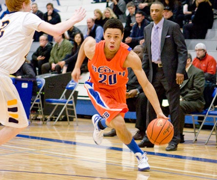 MarQuis Davis, driving past a defender here in front of head coach Mike Bethea, averaged 14.6 points per game as a junior for a loaded Rainier Beach squad that finished 27-3.