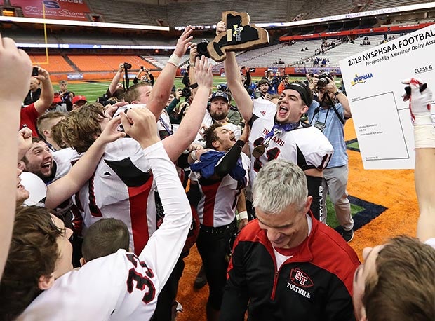 Glens Falls and quarterback Joe Girard III (center) celebrate winning the 2018 NYSPHSAA Class B state title.
