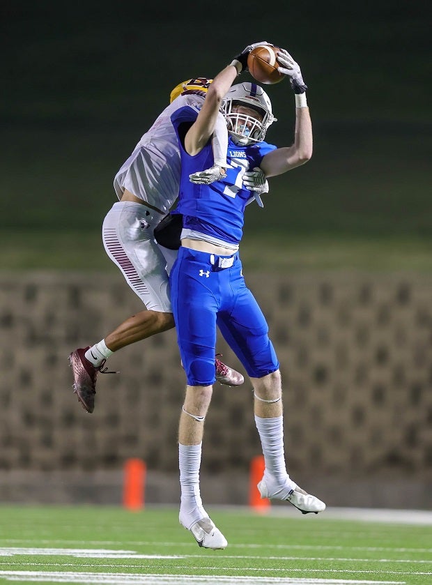 Blooming Grove wide receiver Jace Trull hauls is a grab with a Bells' defender draped on his back in a Texas playoff game. (Photo: Robbie Rakestraw)